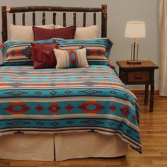 a bed with blue and red bedspread in a room