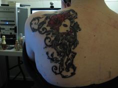 a woman with a tattoo on her back