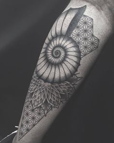 a black and white photo of a tattoo on the arm