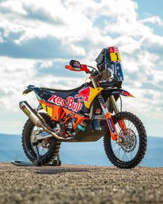 a colorful dirt bike parked on top of a hill