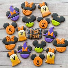 mickey mouse cookies are arranged in the shape of trick - or - treat hats and pumpkins