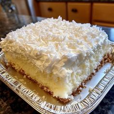 a piece of cake sitting on top of a metal pan covered in white frosting