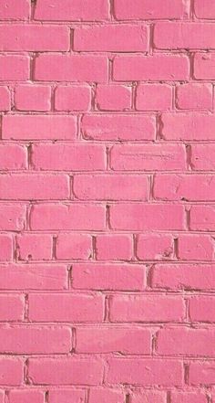 a pink brick wall is shown in this image