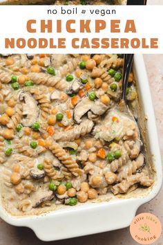 chicken noodle casserole with peas and carrots in a white dish