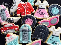 decorated cookies are arranged in the shape of clothes and shoes for babies to be dressed up