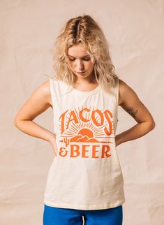 Tacos & Beer: a match made in food heaven. With this soft cotton graphic muscle tank featuring a desert sunrise, you'll always have the ingredients for a great time. Each women's tee is proudly printed in the USA using eco-friendly inks. Features: Cream Colored Tee High-Quality Cotton Fabric Fashion-Fit Cut Screen-Printed in the USA with Eco-Friendly Ink Available in Cream Color Machine Wash >> Find our size chart: pyknic.com/pages/sizing-chart >> We're on Instagram! Follow @Pykn Beer Shirts For Women, Craft Beer Shirts, Taco Tshirt, Desert Sunrise, Food Shirt, Taco Shirt, Festival Shirts, Food Heaven, Womens Tank Tops