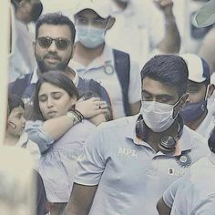 a group of people wearing masks and standing together