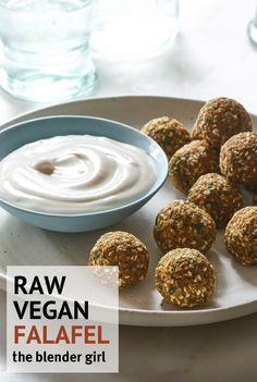 a white plate topped with balls of food next to a bowl of yogurt