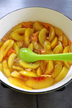 a white bowl filled with food and a green spoon