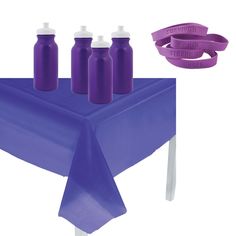 purple table cloth with six bottles on it and two rubber bands around the edges to hold them