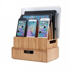 the cell phone holder is made out of bamboo and holds four different types of phones