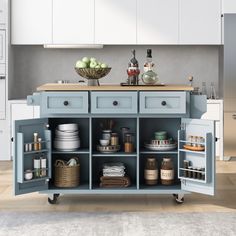 a blue kitchen island with lots of dishes on it