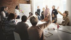 a group of people sitting around a conference table