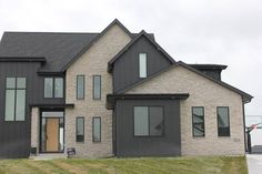 a large house with lots of windows and grass