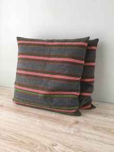 two pillows sitting on top of a wooden floor