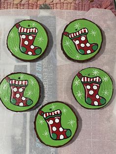 four decorated christmas cookies sitting on top of a piece of paper next to each other