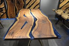 the table is made out of wood and has blue veining on it, along with other pieces of furniture