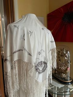 A lovely silk crepe shawl with machine embroidered flowers and leaves in shades of gray. In excellent clean laundered condition  Measures  30" plus 8" of drinks he Luxury Embroidered Wedding Shawl, Embroidered Silk Shawl Scarf, Embroidered Silk Scarf Shawl For Wedding, Embroidered Silk Shawl For Wedding, White Silk Shawl Scarf, One Size, White Silk Pashmina Shawl, Embroidered Silk Shawl, Shades Of Gray, Silk Shawl