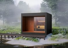 an outdoor sauna is shown in the foggy woods