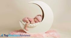 a baby is sleeping in a crescent shaped bed