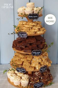 a tiered cake with lots of different types of pastries on it and a sign that says prop options see more