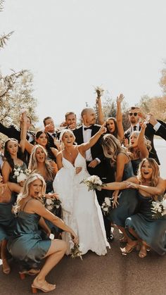 a group of people that are standing in the street with their arms in the air