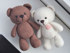 two crocheted teddy bears sitting next to each other