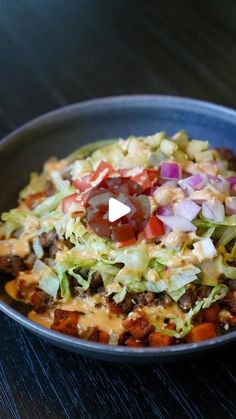 a bowl filled with lots of food on top of a table