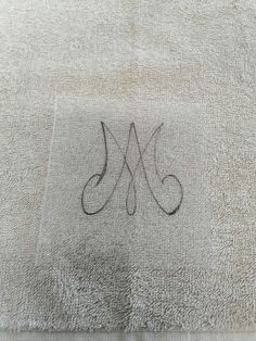 the monogrammed letter m is shown on a white rug