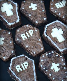 chocolate cookies with white frosting and crosses on them that say rip in the middle