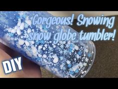 someone is holding a water bottle with snow flakes on it and the words, gorgeous spring show globe tumbler diy