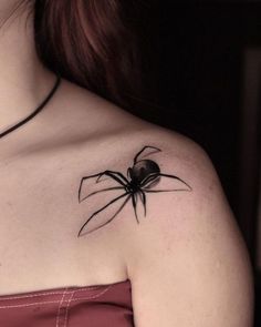 a woman with a spider tattoo on her shoulder