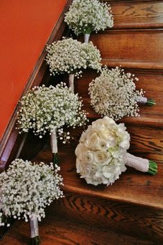 wedding bouquets are lined up on the stairs