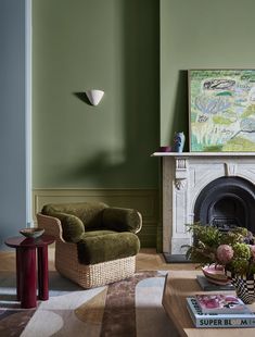 a living room filled with furniture and a fire place in front of a painting on the wall