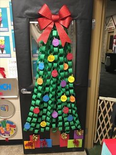 a christmas tree made out of toilet paper and some magnets on the front door