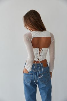 So trendy in the Rio Corset Shrug Set! This corset top is complete with a strapless fold over neckline, a lace up back with silver grommets, and a mesh long sleeve shrug. Available in black and white. Pair with your favorite jeans to complete the look! Details Top self: 95% Nylon, 5% Spandex Top lining 92% Polyester, 8% Spandex Shrug self: 90%, Nylon, 10% Spandex Shrug lining: 92% Polyester, 8% Spandex Item sold as set Silicon grips Boning Material has some stretch Machine wash cold / Tumble dry White Strapless Top, Long Sleeve Shrug, Sleeve Shrug, American Threads, Spandex Top, Mesh Long Sleeve, Ruffled Maxi Dress, Lace Ruffle, Sweater Sale