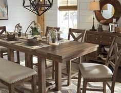 a dining room table with chairs and a chandelier