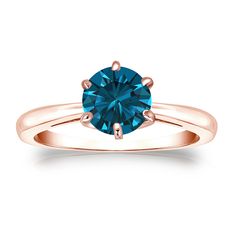 a rose gold ring with a blue diamond