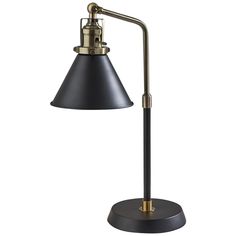 a black and gold desk lamp with a metal base on an isolated white background photo