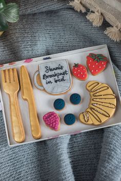 an assortment of decorated cookies in a box