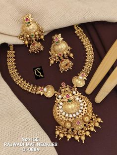 Description :- Gift yourself a royal look with this perfectly crafted kundan necklace set from Manalisstudio. Crafted with high quality kundan stones and pearls, it is impressive in design. The green enamel artwork adds perfect texture to the design. Perfect for weddings and festivities, this antique necklace set should be put on with your favorite sari or lehenga. 100% Satisfaction. Long Lasting Plating, High-Quality Stones. Gifting :- This necklace and earring set comes in a beautiful manaliss Festive Chandbali Jewelry Sets For Wedding, Festive Chandbali Jewelry Sets For Marriage, Temple Jewelry Sets For Marriage With Meenakari, Temple Jewelry Style Kundan Necklace For Marriage, Temple Style Kundan Necklace For Marriage, Chandbali Kundan Necklace For Marriage, Formal Gold Kundan Choker, Festive Gold Plated Kundan Choker Necklace, Festive Gold Kundan Choker