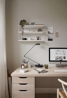 a white desk with a computer on top of it