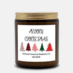 a jar of merry christmas candles with trees on the front and bottom, next to a white background