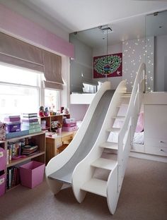 a room with a slide in the middle and shelves on the wall next to it