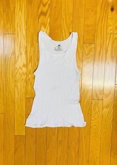 "An awesomely distressed & broken in white ribbed cotton Hanes undershirt / wifebeater / tank top.  Distressed from the 90s Grunge club era here in the PNW.  Has a ton of stretch and the original vintage label size is L but, as always, please check current approximate measurements for size. Gender neutral. 💥Condition: Excellent vintage distressed condition. Has a couple of light greyish streaks across the front center -- see pix. No holes, tears, rips, etc.  Measurements are taken while the garment is lying flat. Please double where appropriate for actual dimensions. 💥MEASUREMENTS💥 Approximate Measurements (lying flat):  Width armpit to armpit: 13\" Bottom hem width: 17\" Length shoulder top to bottom hem: 25.5\" Please be sure the approximate measurements are a good fit for you. Make s Stretch Cotton Racerback Tops, White Stretch Racerback Top, White Distressed Fitted Tops, White Fitted Distressed Tops, Fitted White Distressed Tops, Distressed Fitted Cotton Tank Top, Fitted Distressed Cotton Tank Top, Fitted Distressed Cotton Tops, Distressed White Cotton Tops