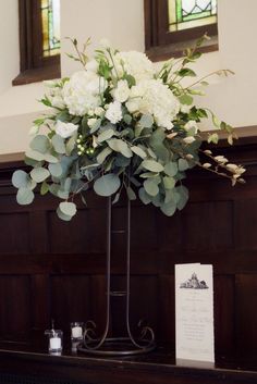 a vase filled with white flowers on top of a table