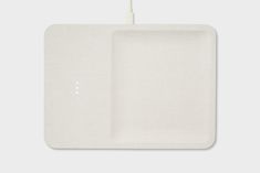 a white square plate with a cord attached to it