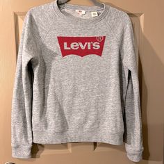 Levi’s Jeans ~ Logo Sweatshirt This Is A Great Shirt!! Inside Lining Is Soft!! New Without Tags Levi's Casual Cotton Sweatshirt, Casual Levi's Cotton Sweatshirt, Levi's Sporty Crew Neck Top, Levi's Sporty Relaxed Fit Top, Basic Winter Tops With Logo Print, Levi's Logo Print Crew Neck Top, Levi's Casual Letter Print Tops, Levi's Casual Tops With Letter Print, Casual Levi's Tops With Letter Print