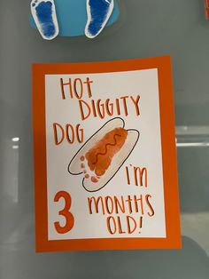 a hot dog sign is hanging on a refrigerator door with magnets attached to it