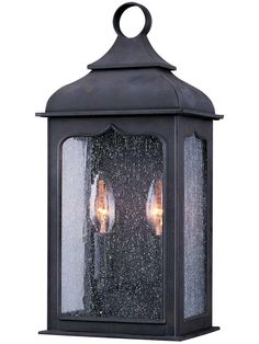 two light outdoor hanging fixture with frosted glass and metal finish on the outside wall